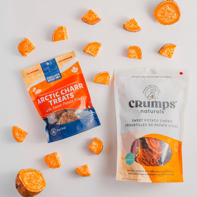 Crumps Natural Sweet Potato Dog Treats pack with orange sweet potato chews and Arctic Charr Treats nearby