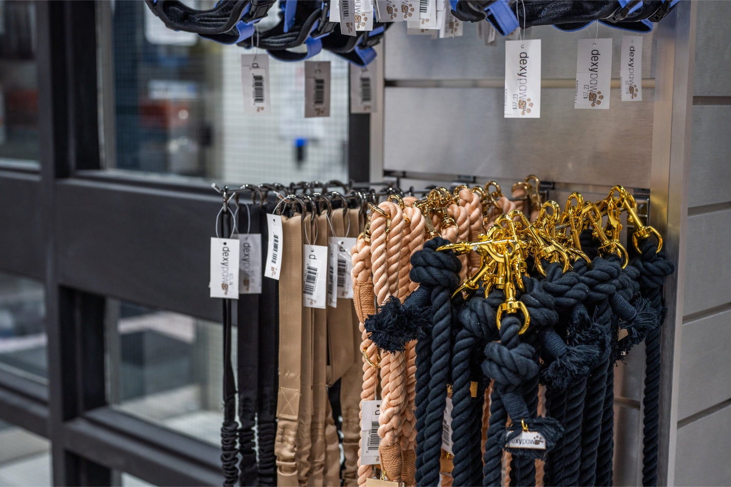 Dexypaws hands free dog leash black displayed hanging with other dog accessories at a store