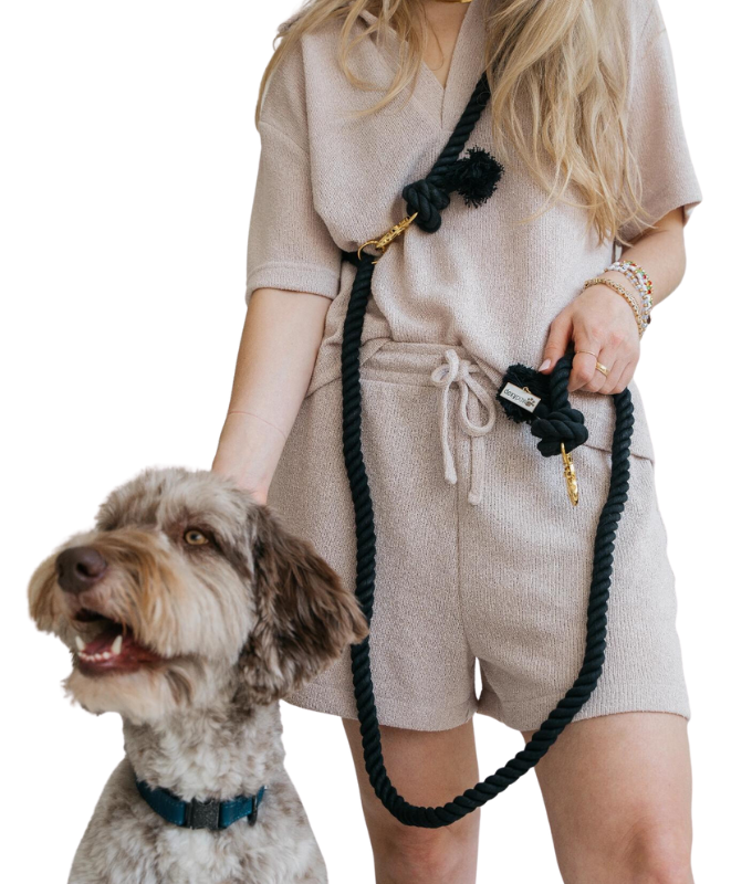 Woman holding a dog with dexypaws hands free dog leash black in a casual outfit