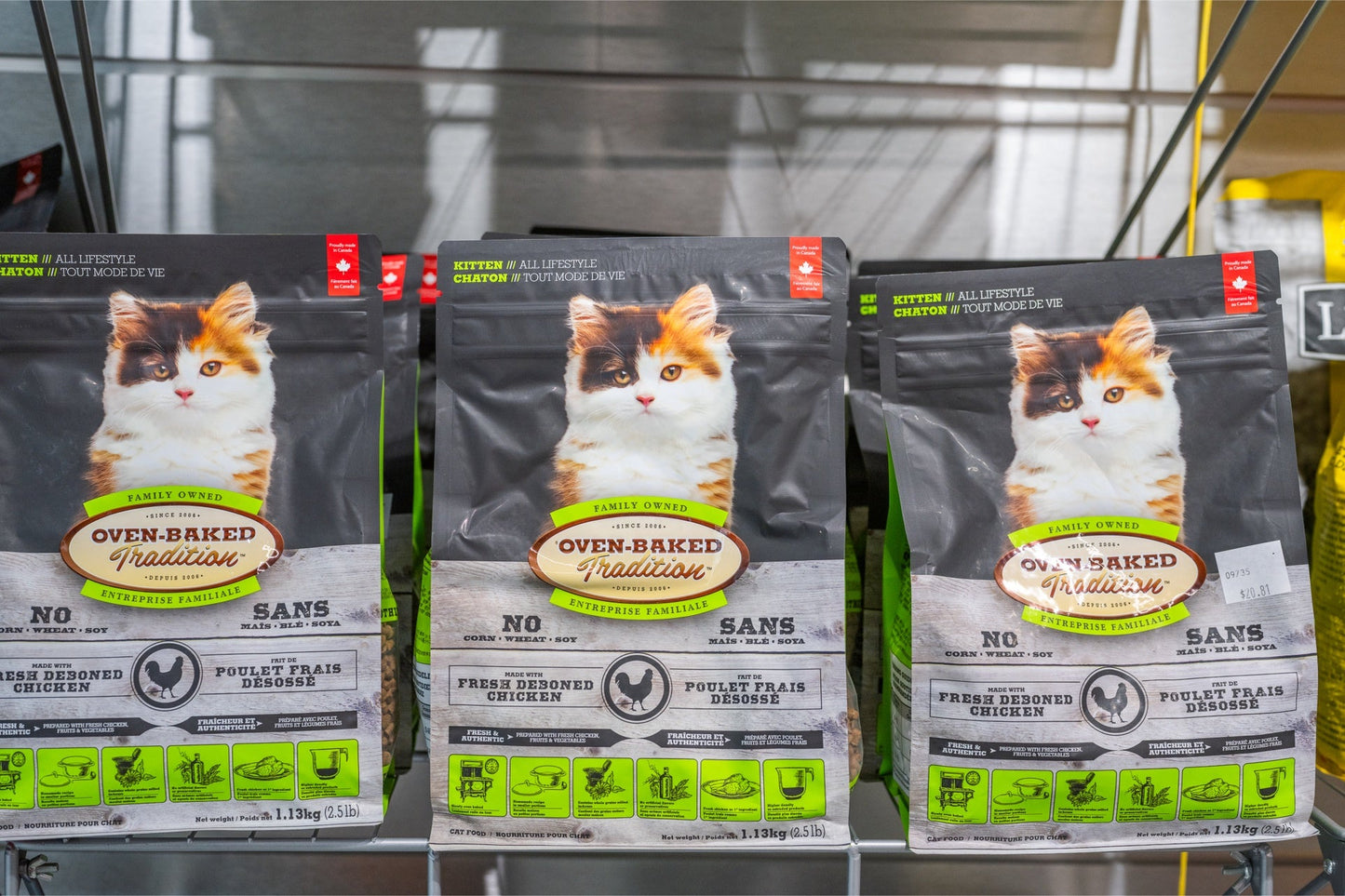 Oven Baked Tradition kitten chicken food bags displayed on a shelf for pet owners