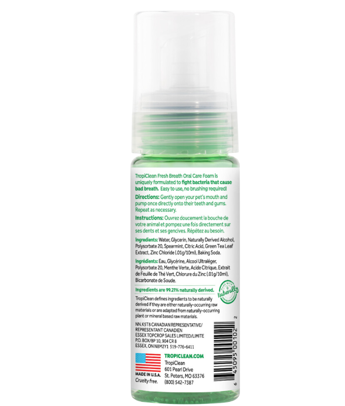 TropiClean dog oral care foam bottle showing ingredients and usage instructions for dog grooming