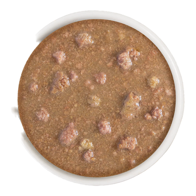 Close-up of Weruva OMG Be Happy cat food in a white bowl showing wet canned food texture