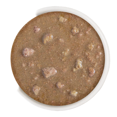 Close-up of Weruva omg stir canned cat food showing wet texture with meat chunks in a white container