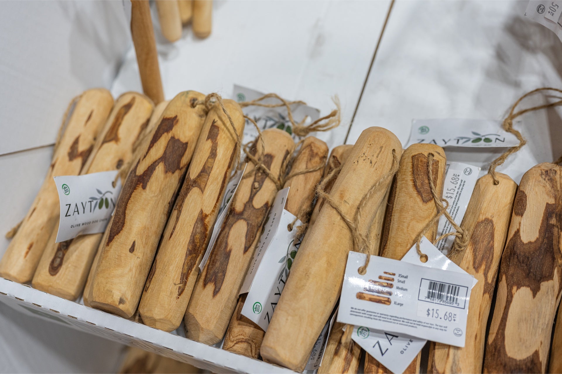 Zaytoon extra large olive wood dog chew sticks arranged in a display box for durable dog toys