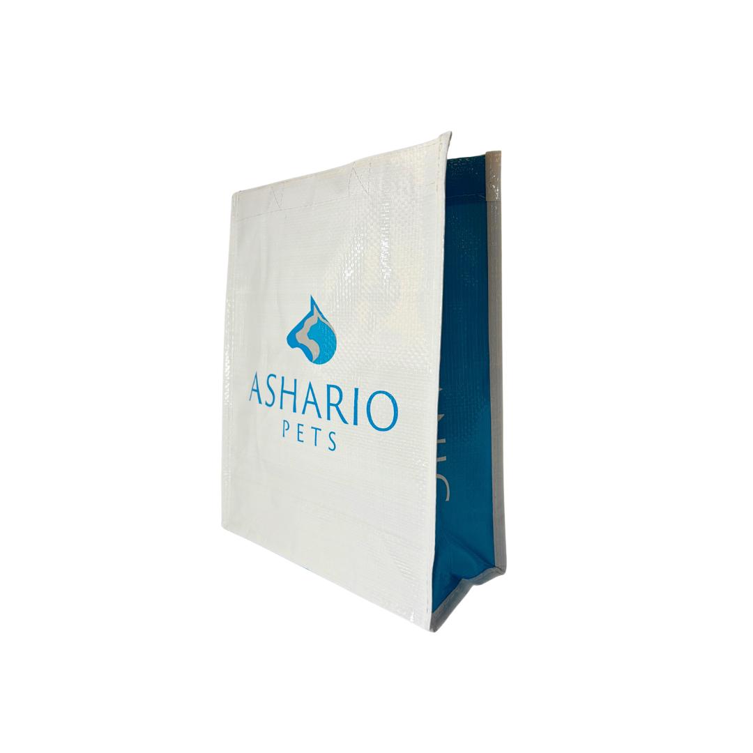 White and blue Ashario Pets reusable bag with logo for eco-friendly pet product storage
