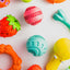 Variety of colorful dog toys including the Ashario teeth cleaning ring for playful pups