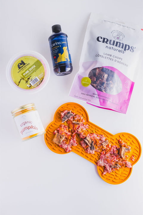 Crumps' Natural dehydrated lamb chop for dogs displayed on a bone-shaped mat with other pet food items