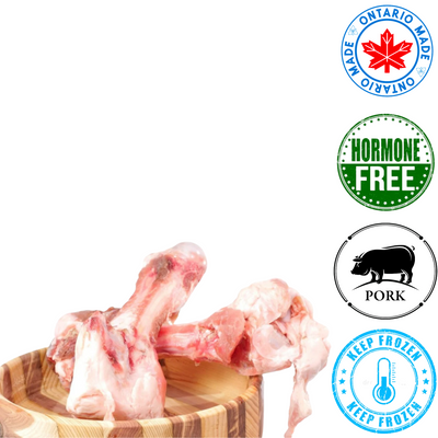 Raw Performance pork femur dog treats on a wooden bowl, hormone-free and made in Ontario
