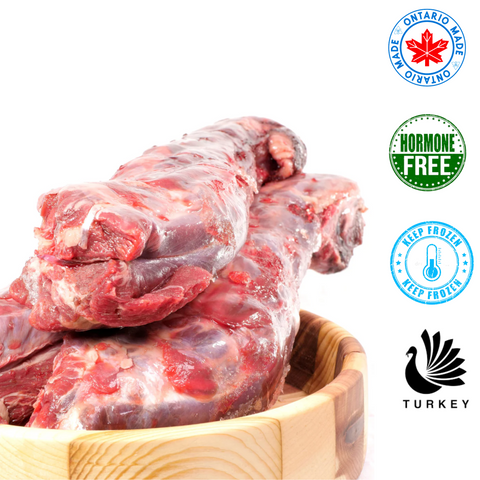 Raw Performance raw turkey necks for dogs stacked in a wooden bowl showing fresh hormone-free frozen turkey meat