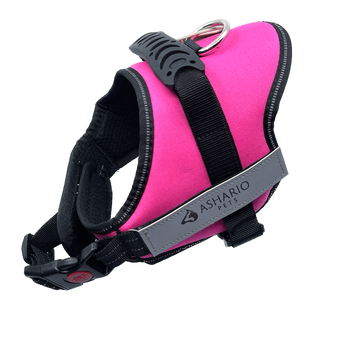 Bright pink dog harness with reflective straps, designed for safety and comfort during walks, adjustable fit suitable for all dog sizes.